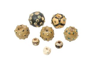 A GROUP OF EIGHT CHINESE GLASS 'EYE' BEADS 東周至漢 蜻蜓眼琉璃珠