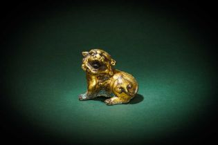 A CHINESE GILT-BRONZE FIGURE OF A LION 明 銅鎏金獅形擺件