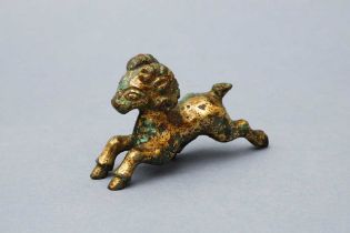 A CHINESE GILT-BRONZE MODEL OF A RAM 漢 銅鎏金羊