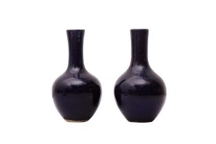 TWO SMALL CHINESE MONOCHROME BLUE-GLAZED VASES 清乾隆 藍釉長頸瓶兩件