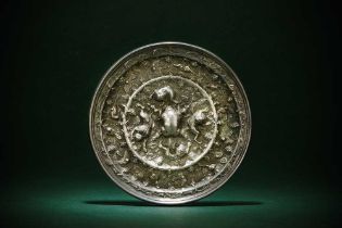 A CHINESE SILVERED BRONZE 'LION AND GRAPE' MIRROR 唐 狻猊葡萄紋鍍銀銅鏡