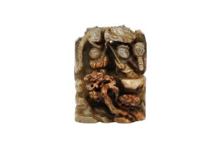 A CHINESE GREY JADE CARVING OF BOYS ON A MOUNTAIN 清十九世紀 灰褐玉雕童子舞龍