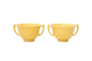 A PAIR OF CHINESE YELLOW-GLAZED INCISED 'DRAGON' TWIN-HANDLED CUPS 黃釉暗刻龍趕珠紋雙耳盃一對
