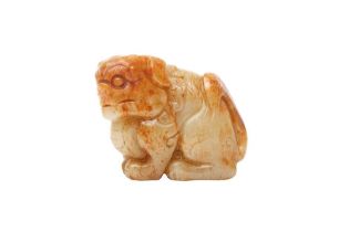 A CHINESE CELADON AND RUSSET JADE 'LION DOG' CARVING 清十九世紀 青玉糖色雕佛獅