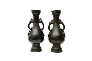 A PAIR OF CHINESE BRONZE TWIN-HANDLED VASES 明 銅瑞獸活耳瓶一對