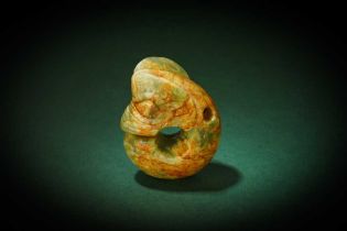 A GREEN AND RUSSET JADE CARVING OF A 'PIG DRAGON' 紅山文化 玉豬龍