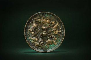 A SMALL CHINESE BRONZE 'LION' MIRROR 唐 海獸紋銅鏡