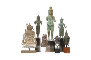 A GROUP OF BRONZE FIGURES AND A SILVER PLAQUE