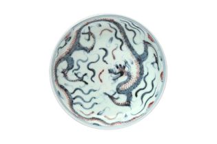 A JAPANESE BLUE AND WHITE AND COPPER-RED 'DRAGON' DISH