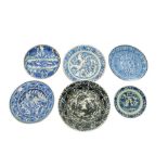 SIX ASIAN-INSPIRED BLUE AND WHITE POTTERY DISHES WITH FIGURAL AND VEGETAL MOTIFS Iran, 18th - 19th c
