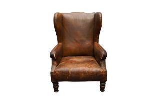 A 19TH CENTURY HUMPBACK WING ARMCHAIR