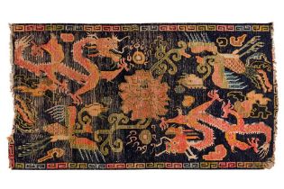 AN ANTIQUE TIBETAN DRAGON DESIGN RUG