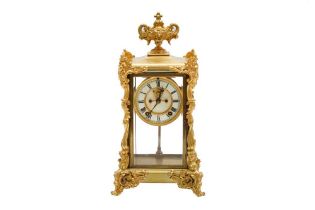 A ROCOCO STYLE ORMOLU FOUR GLASS MANTEL CLOCK