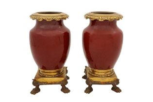 A PAIR OF SANG DE BOUEF MOUNTED VASES