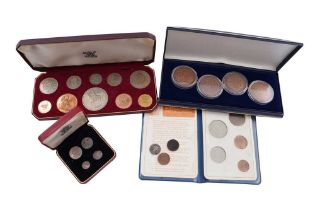 FOUR SETS OF CASED COINS