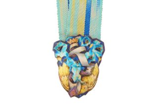 FRED RICH | A SAPPHIRE AND ENAMEL RIBBON PENDANT