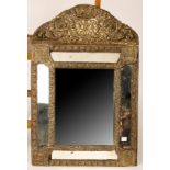 An Italian embossed brass mirror, monogrammed,