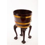 A George III mahogany and brass bound bucket, on later carved legs with claw and ball feet,