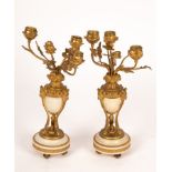 A pair of alabaster and ormolu mounted three-branch candlesticks,