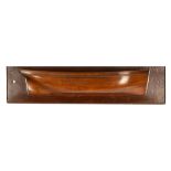 A carved and moulded fruitwood half-hull, mounted on a board,