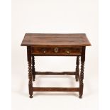 A late 17th Century elm table fitted a drawer on spiral legs,