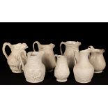 Fifteen saltware jugs, various patterns, the largest 25.