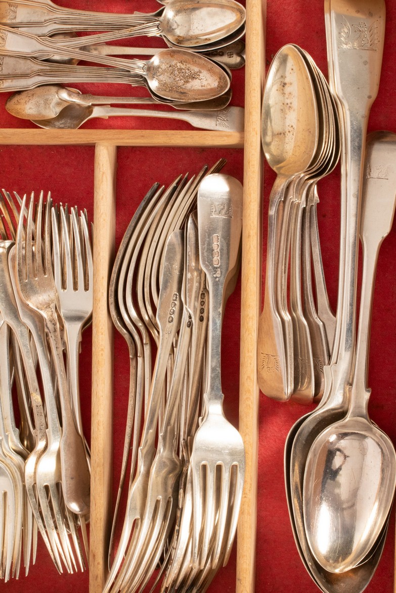 A quantity of Georgian fiddle pattern silver flatware, various makers, all bearing crest of Coxwell,