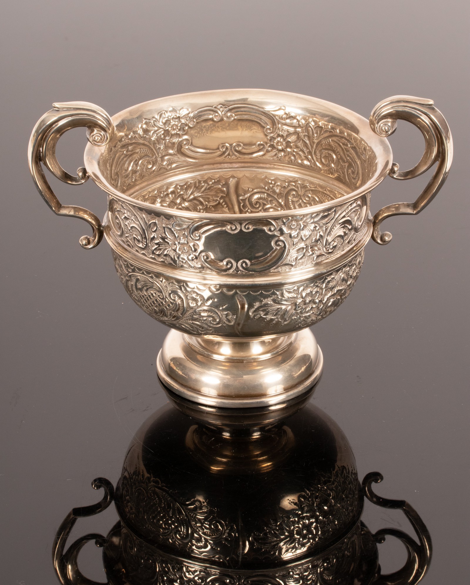 An Edwardian silver two-handled cup, Birmingham 1909, with embossed decoration, 16. - Image 2 of 3