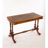 A Victorian walnut writing table on twin-end standards and splay feet, fitted a frieze drawer, 106.