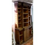 A Victorian mahogany breakfront bookcase, circa 1840, the moulded cornice above open shelves,
