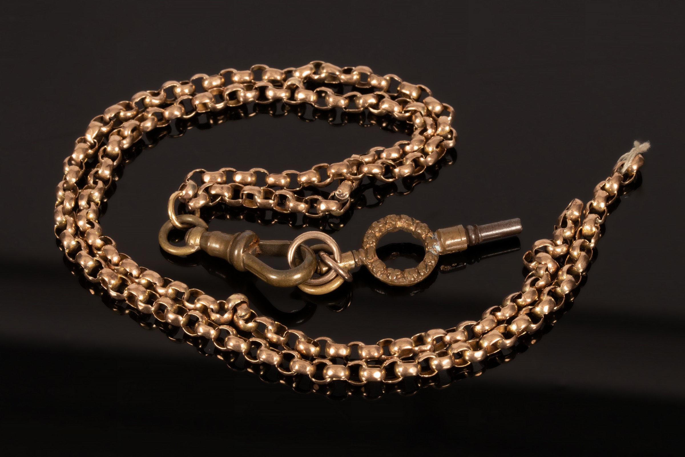 A 9ct yellow gold chain, broken, with plated clip and watch key, chain approximately 9.