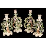 Four Derby style animal candlesticks modelled as dogs below birds in bocage CONDITION