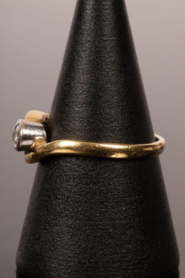 A diamond three-stone ring in an 18ct yellow gold crossover setting, the inner shank marked . - Image 2 of 2