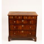 An early 18th Century walnut chest of three long and two short drawers on bracket feet,