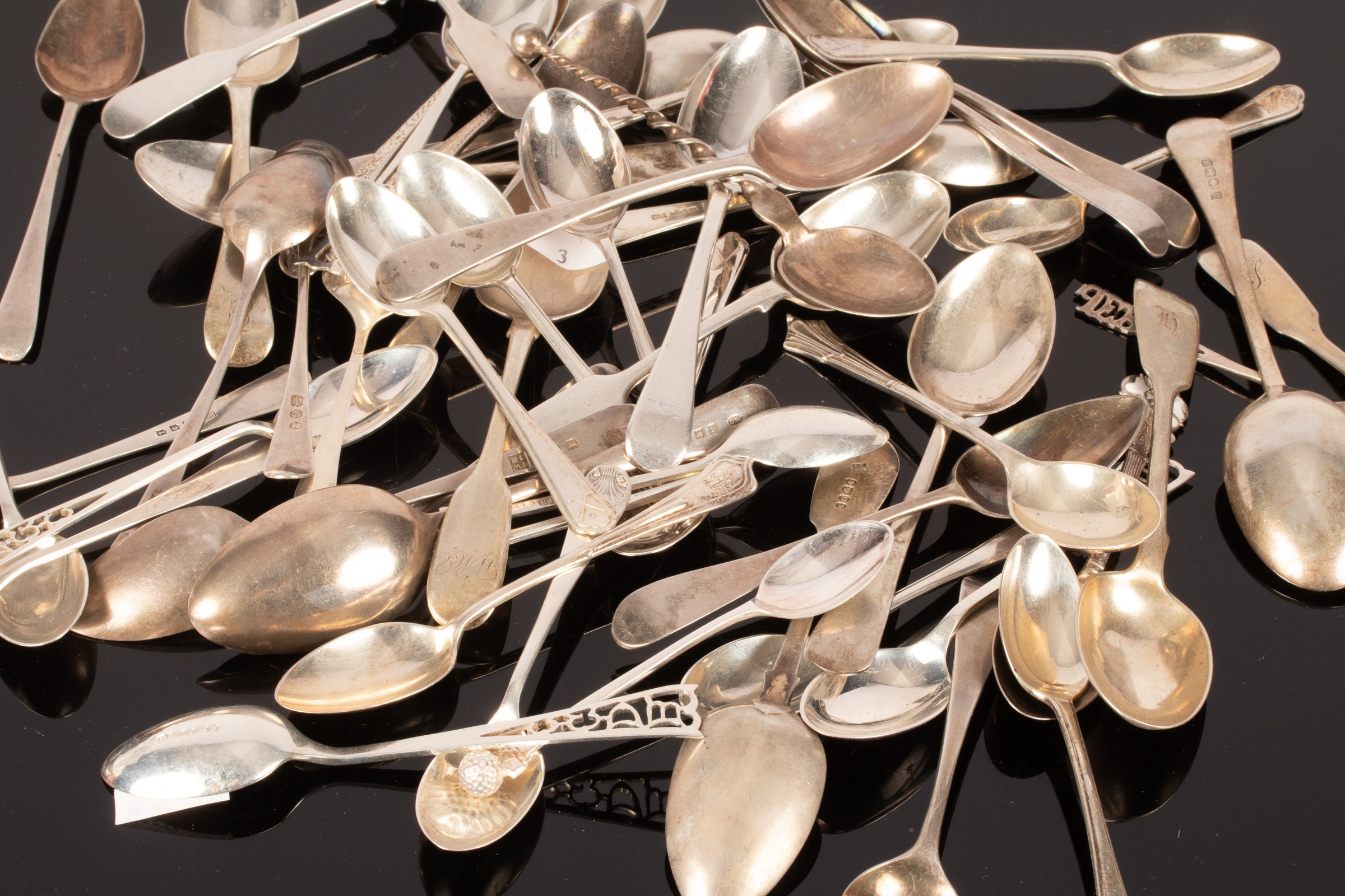 A quantity of sundry silver teaspoons to include four novelty golfing teaspoons with golf ball