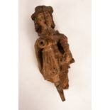 A 17th Century carved figure of a man, traces of polychromatic decoration,