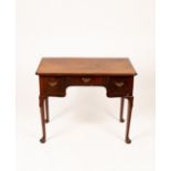 A George III mahogany lowboy, the central drawer flanked by two deep drawers,