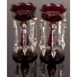 A pair of ruby glass lustres, with petal cut rims and clear drops,