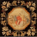 An early Victorian needlework picture, depicting a Biblical figure within a wreath surround,