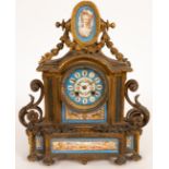 A gilt metal and porcelain mantel clock, twin-train movement striking a bell,