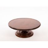 A 19th Century mahogany lazy Susan on a turned column,