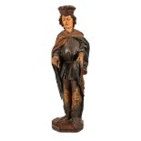 A carved and painted figure of St Martin, early 19th Century,