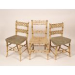 A pair of painted faux bamboo chairs with quatrefoil detail and another similar example