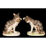 A pair of Continental porcelain models of seated cats, 20th Century,