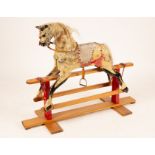 A dapple-grey rocking horse on an American rocker,