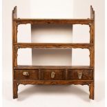 A set of elm hanging shelves fitted three drawers,