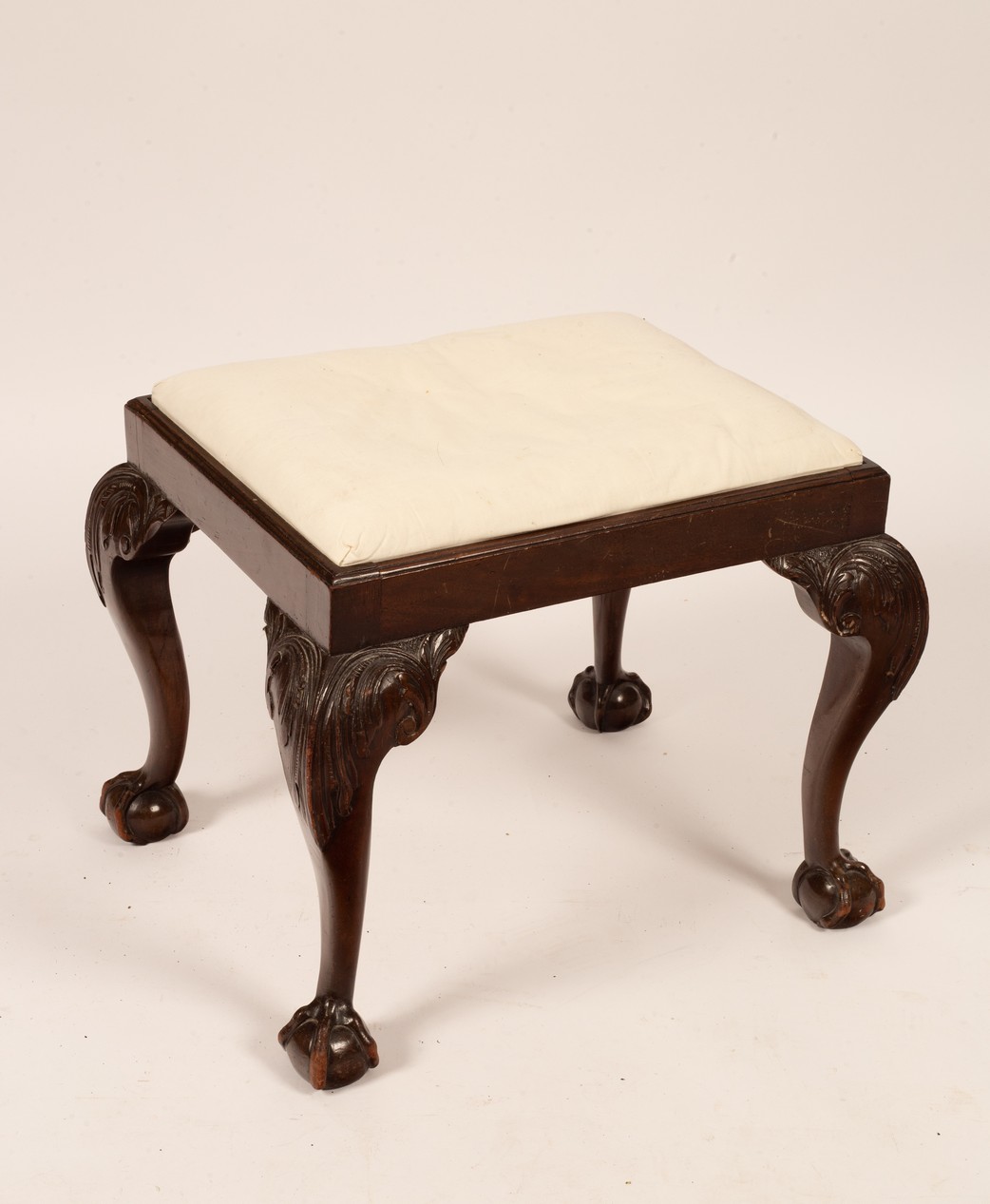 A rectangular stool on carved legs with ball and claw feet CONDITION REPORT: