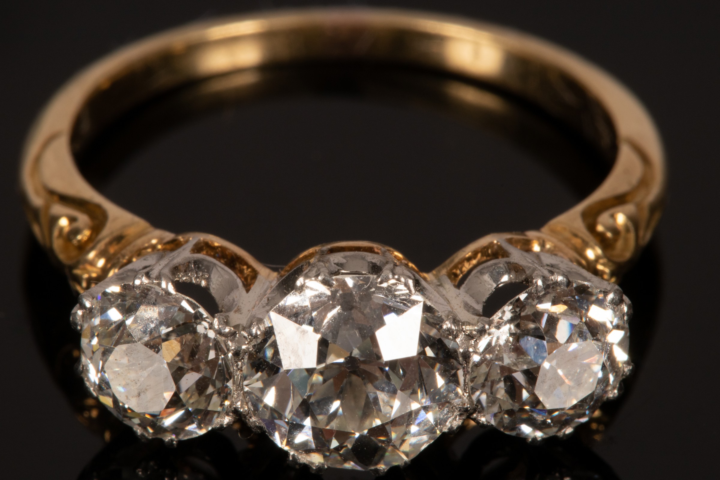 A diamond three-stone ring, the central stone of approximately 1.