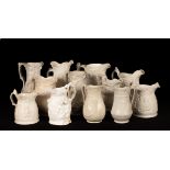 Twelve saltware jugs, various patterns,
