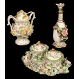 Three items of 19th Century English flower encrusted porcelain, an inkstand, 22cm wide, a bottle,